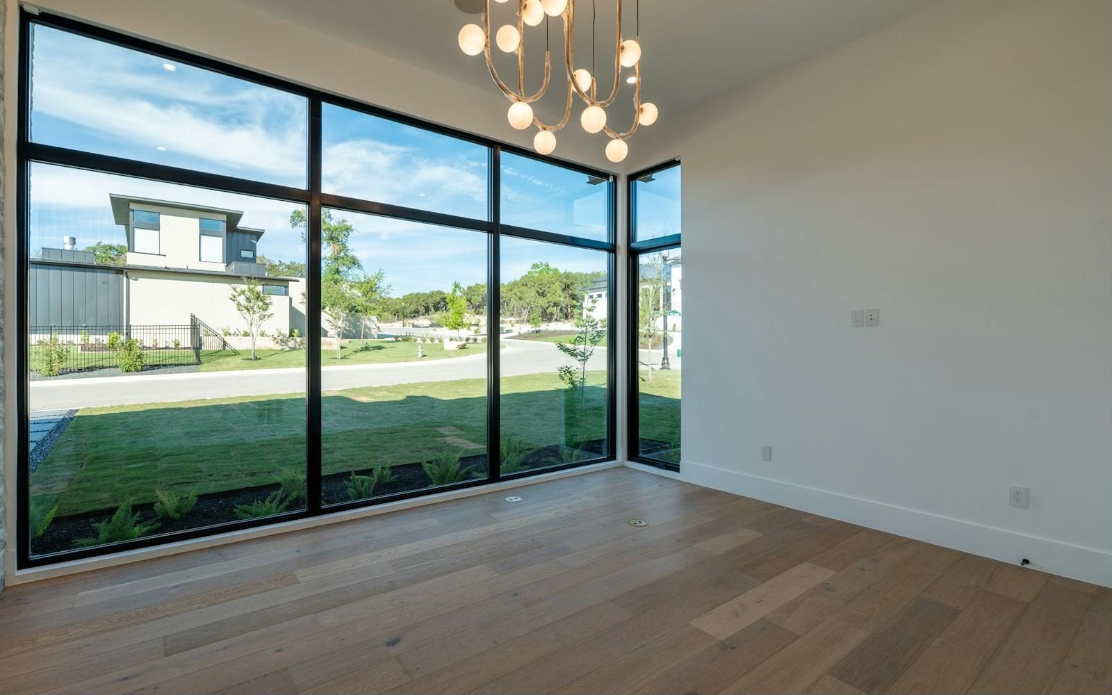 Room with new floor-to-ceiling black-framed windows